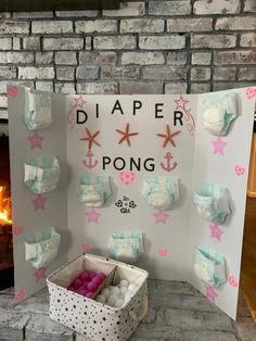 a paper pong game is set up in front of a fireplace with pink and blue decorations