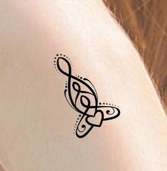 a close up of a person's arm with a tattoo design on the side