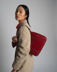 A timeless, sustainably made luxury shoulder bag. Luxury Square Baguette Bag For Travel, Timeless Red Top Handle Shoulder Bag, Business Baguette Bag With Removable Pouch, Versatile Red Rectangular Shoulder Bag, Timeless Red Satchel Shoulder Bag, Designer Rectangular Baguette Bag For Business, Luxury Everyday Rectangular Laptop Bag, Timeless Red Shoulder Bag For Daily Use, Timeless Shoulder Baguette Bag For Travel