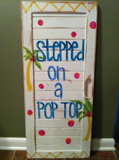 a white cupboard with the words stepped on a pop top painted on it's door