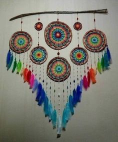 a multicolored dream catcher hanging on a wall