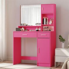 a pink desk with a mirror and drawers