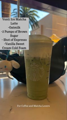 a starbucks drink is sitting on a table with information about the drinks in front of it