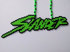 a green necklace with the word snake on it