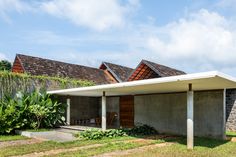 the house is made out of concrete and has two roof tops on each side, while another