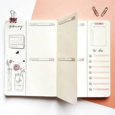 an open planner book sitting on top of a pink table next to a pair of scissors