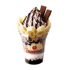 an ice cream sundae with chocolate and bananas in a plastic cup on a white background