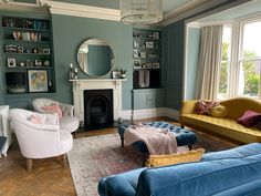 a living room filled with furniture and a fire place