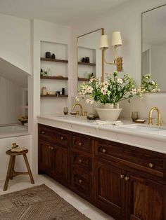 a large bathroom with two sinks and mirrors