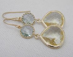 A citrine glass teardrop (15mm x 18.5mm) dangles from a prasiolite faceted cubic zirconia (13.5mm x 8mm) circle in a gold plated brass setting. Overall length of earring approximately 1 1/2 inches. Dangling from an elegant gold plated french ear wire. Includes plastic protectors. Also available in silver, just put preference in notes to seller. All items ship in a gift box USPS first class mail. Gemstone Teardrop Earrings For Wedding, Gold Teardrop Gemstone Earrings For Wedding, Wedding Gemstone Teardrop Earrings, Wedding Teardrop Gemstone Earrings, Gemstone Teardrop Dangle Earrings For Wedding, Gemstone Dangle Teardrop Earrings For Wedding, Gold Briolette Teardrop Earrings For Wedding, Dangle Teardrop Gemstone Earrings For Wedding, Wedding Gemstone Teardrop Dangle Earrings