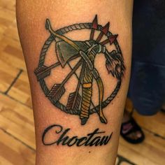 a tattoo on the leg of a person with an arrow and bow in front of it