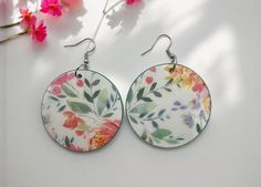 These bright color floral earrings are perfect for any occasion! They are not only perfect for standing out, but they are lightweight and easy to wear. They could also be a perfect gift! Wood base size: 2in diameter Wood finish: Diamond Glaze **NOTE** Each earring is handmade and may have a few blemishes to the finished product which may include tiny bubbles from the diamond glaze. Can be hard sometimes to get all the bubbles out, but they still look great. Also colors may slightly look different from photos due to lighting exposure or from screen projections. Wooden Earrings, Floral Earrings, Bright Color, Wood Finish, Jewelry Earrings Dangle, Decoupage, Etsy Earrings, Glaze, Dangle Drop Earrings