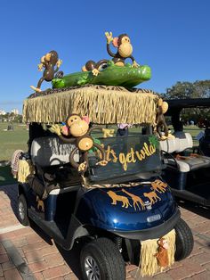 a golf cart decorated with monkeys, bananas and cucumbers