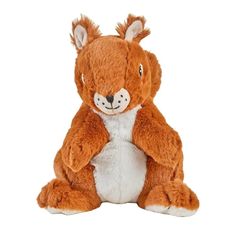 a brown and white stuffed animal sitting on the ground