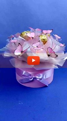 a bouquet of pink and gold butterflies on a blue background