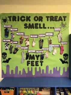 a trick or treat smell board with halloween socks hanging from it's sides and on the wall