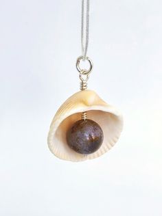 This is a wonderful pendant made of a natural Atlantic seashell and natural Agate. My seashells are harvested on Melbourne beach in Florida. The inner shell has beautiful pink and purple color to it and looks very authentic in combination with agate. The pendant makes a great souvenir from Florida for ocean lovers and sustainable friends.Agate is well known for its calming, soothing effects on the mind, primarily when used over some time. It can help enhance mental clarity and improve concentrat Spiritual Shell Necklace As Gift, Spiritual Handmade Shell Necklace Gift, Handmade Spiritual Shell Necklace Gift, Handmade Spiritual Shell Necklace As Gift, Handmade Natural Shell Necklace For Gift, Spiritual Shell Necklace Gift, Natural Shell Necklace As Gift, Natural Shell Necklace For Gift, Spiritual Shell Necklace With Natural Stones For Gift