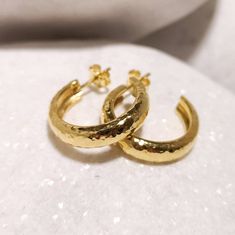 Eye catcher pair of thick chunky hand forged hoop earrings from solid 18k yellow gold. Using only traditional techniques each piece is unique, shaped , forged and hammered by hand, the result is an elegant and classy pair suitable for every occasion. Product details : * solid 18k gold * hand forged * Diameter 2,3 cm * Thickness 5,3 mm Custom orders Custom orders are always welcome! We are very flexible with custom orders and we can accommodate almost any request concerning metal, engravings, sto Hammered Gold Round Huggie Earrings, Gold Hammered Round Huggie Earrings, Gold Plated Polished Hoop Earrings Gift, Handmade Yellow Gold Round Huggie Earrings, Hammered Gold-plated Small Hoop Earrings, Small Hammered Gold-plated Hoop Earrings, Small Gold Plated Hammered Hoop Earrings, Gold Hammered Huggie Earrings, Hammered Yellow Gold Hoop Huggie Earrings