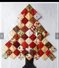 a quilted christmas tree is displayed on a table