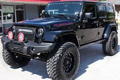 a black jeep parked in front of a building