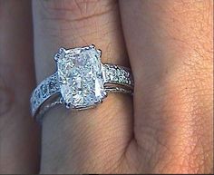 a woman's engagement ring with a cushion cut diamond