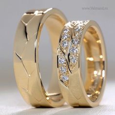 two gold wedding rings with diamonds on them