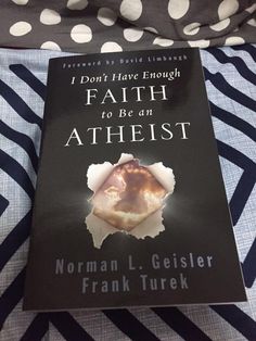 a book about faith to be an atheist on a bed