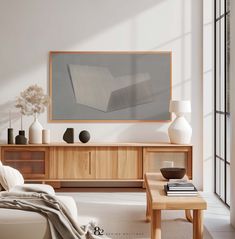 a living room scene with focus on the coffee table and large art piece in the background