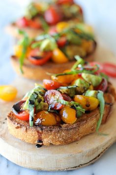 three pieces of bread topped with different types of veggies on top of each other