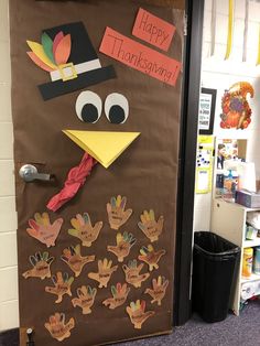 a bulletin board decorated with thanksgiving turkeys and handprinted words on the door