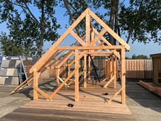 a wooden house being built on top of a deck