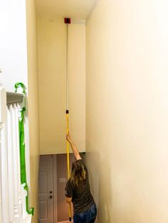 a man is cleaning the stairs with a mop and bucket in an apartment hallway