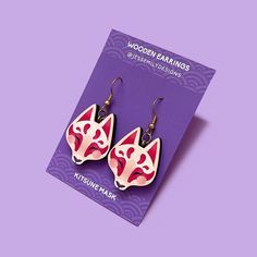 Worn mainly during rice harvest festivals, Kitsune or fox masks are iconic in Japanese culture. Made from responsibly sourced maple, these cute earrings feature a vibrant print and gold tone plated stainless steel hooks Details: Size: 22mm width x 50mm length (from top of hooks to base of charm) Earring hooks: Gold tone plated stainless steel Please note: Actual colours may vary slightly - different screens and devices may alter the true colours of your product. All products are designed and ill Fox Masks, Harvest Festivals, Kitsune Mask, Fox Earrings, Fox Mask, Harvest Festival, Lucky Charms, Wooden Earrings, Earring Hooks