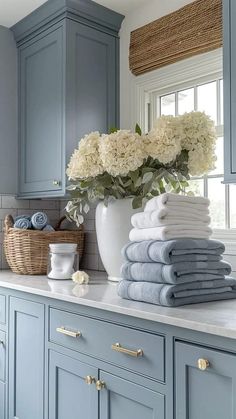 towels are stacked on top of the kitchen counter