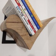 a wooden book holder with books on it