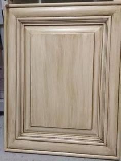 an unfinished cabinet door is shown in the process of being painted