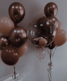 balloons with writing on them are hanging from the wall