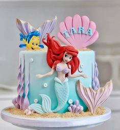 the little mermaid cake is decorated with fondant