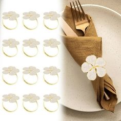 a white plate topped with lots of napkins next to a set of gold forks