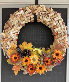 a wreath made out of wine corks and autumn leaves