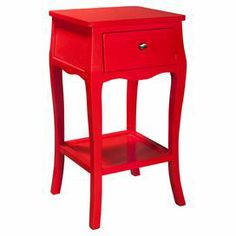 a small red table with a drawer on it