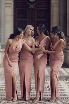 the bridesmaids are all in pink dresses and one is holding her hand out