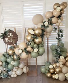 balloons and greenery are arranged in the shape of letters that spell out oh baby