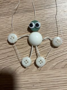 a close up of a toy on a table with buttons and wires attached to it