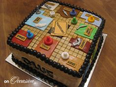 a cake that is sitting on top of a table with writing and game pieces on it