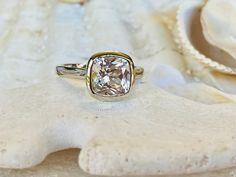 This classic bezel mounting contains a beautiful 2.00 ct. lab created cishion cut white sapphire. The cushion cut stone measures approximately 8x8mm. The ring is approximately 2.1mm wide. The ring is available in sterling silver, and 14k white, yellow, or rose gold. This ring makes a great promise or engagement ring. Please send me a message if you need a size not listed. * This ring can be customized with any color center stone. All items are handmade by me in my shop in Woodbridge, NJ. Please Sapphire Bezel Ring, Prasiolite Ring, White Sapphire Engagement Ring, Blue Topaz Engagement Ring, Green Amethyst Ring, Ring Cushion, White Sapphire Ring, Cushion Cut Ring, Sapphire Solitaire