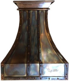 an old fashioned copper range hood is shown