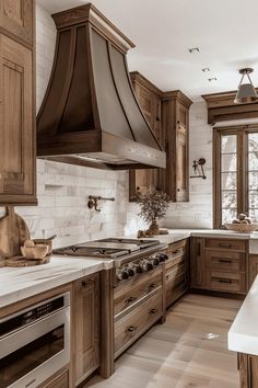 a large kitchen with wooden cabinets and white counter tops is pictured in this image, there are two ovens on either side of the stove