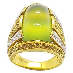 Prehnite 11.87 carats, Yellow Sapphire 1.47 carats and Diamond 0.53 carat Ring set in 18 Karat Gold Settings Width: 2.0 cm Length: 1.9 cm Ring Size: 51 Total Weight: 13.57 grams "We first opened doors in 1980 when it was then situated in the vicinity of the Victory Monument; a small and modest storefront with a couple of counters. From its humble beginnings to where it stands today, our company has proven its abilities as a jeweler. Since the beginning, we have been supplying fine quality pieces Luxury Multi-stone Yellow Gemstones, Luxury Yellow Multi-stone Gemstones, Luxury Oval Cabochon Gemstones, Luxury Diamond Cabochon Gemstones, Luxury Diamond Gemstones With Cabochon Cut, Luxury Green Oval Gemstones, Luxury Oval Cabochon Diamond Gemstones, Luxury Yellow Gold Oval Cabochon Gemstones, Luxury Yellow Diamond Gemstones