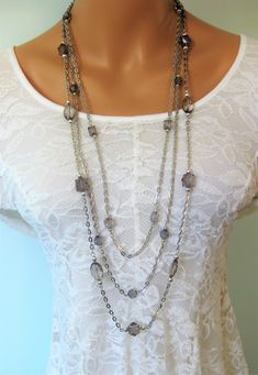 Long Gray Beaded Necklace for Women, with multi strands of silver chains, handmade by Ralston Originals.   Handmade Jewelry for Women, Womens Jewelry, Long Necklaces I made this necklace with 3 long multi strands of beaded chains, with different sized and shapes of gray acrylic beads, and silver acrylic beads. It is just like the blue, purple and red one in my shop.  The acrylic beads make this necklace lightweight and comfortable. This long necklace is great with a black dress. The necklace is Silver Beaded Chain Necklace For Layering, Silver Double Strand Beaded Necklaces For Layering, Silver Necklaces With Beaded Chain For Layering, Silver Multi-strand Layered Necklace With Beaded Chain, Silver Multi-strand Beaded Chain Necklace, Handmade Silver Necklaces For Layering, Elegant Handmade Silver Layered Necklace, Silver Bohemian Beaded Necklaces For Layering, Silver Multi-strand Chain Necklace